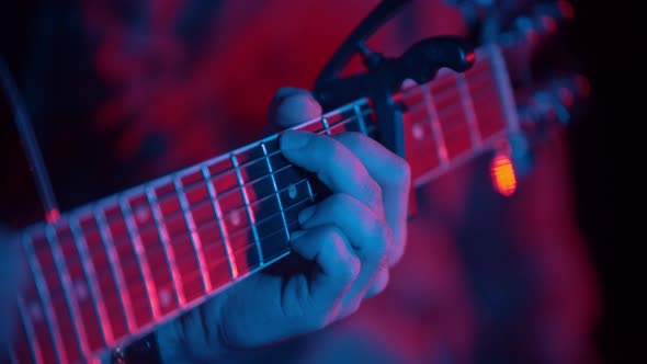 Musicians Concept - Playing Guitar in Neon Lighting