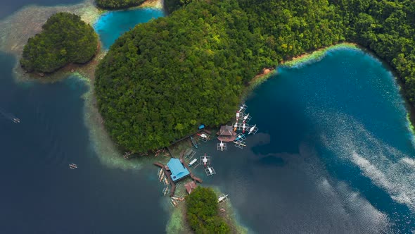 Aerial Top View Boat Pier in a Beautiful Tropical Bay on Sugba Lagoon in Siargao, Philippines.