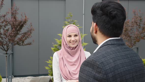 Businessman Woman in Hijab and Muslim Businessman Shaking Hands to Each Other