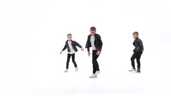 Kids Are Dancing a Modern Dance on the White Background in Black Leather Jackets and Jeans