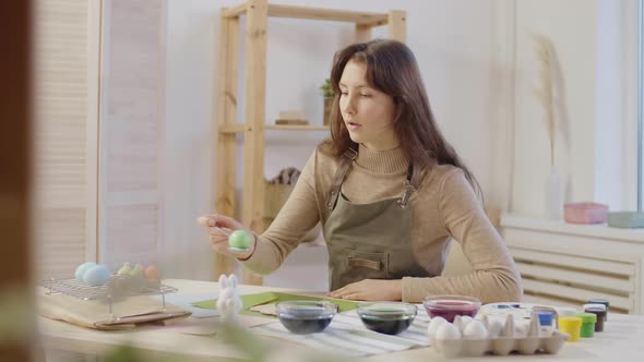 Charismatic Young Woman Dyeing Easter Eggs