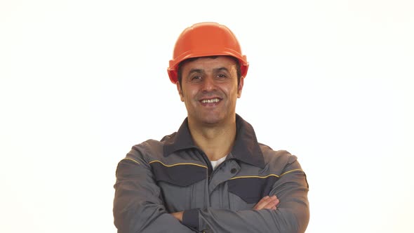 Cheerful Mature Constructionist in Hardhat Showing Thumbs Up