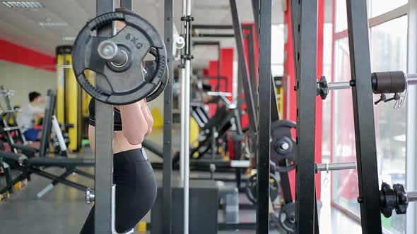 Young Woman With Beautiful Sportive Body Fails to Raise Heavy Dumbbell in Gym