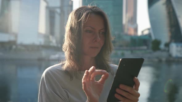 Modern Woman with Smartphone in City Center Using Social Networking and Apps in Gadget