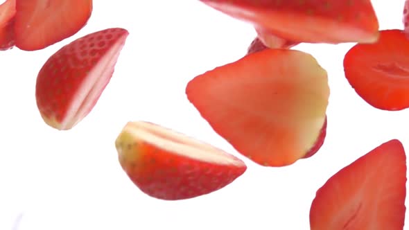 Closeup of the Halves of Delicious Strawberries Falling Diagonally