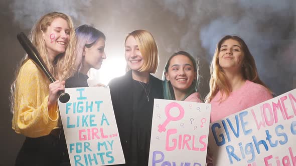 Young Beautiful Women Stand Together in Smoky Space