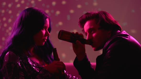 Young Man and Woman Drinking Beer and Flirting at Club Party, Carefree Life