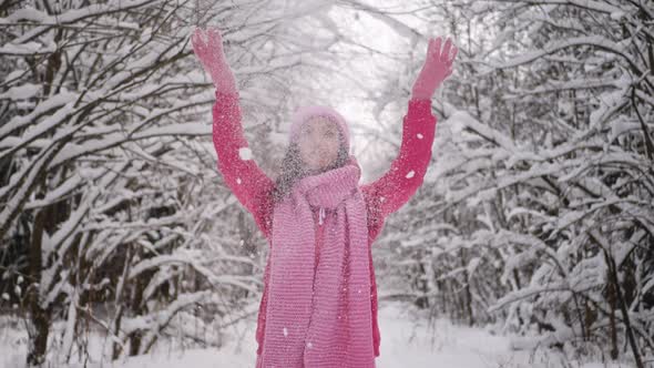 Woman in Pink Clothes a Knitted Hat and a Scarf