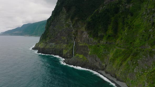 Veu da Noiva waterfall cascading into Atlantic ocean; Seixal, Madeira