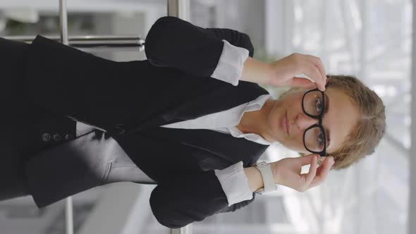 Vertical Shot of Happy Successful Businesswoman Posing in Office Hall