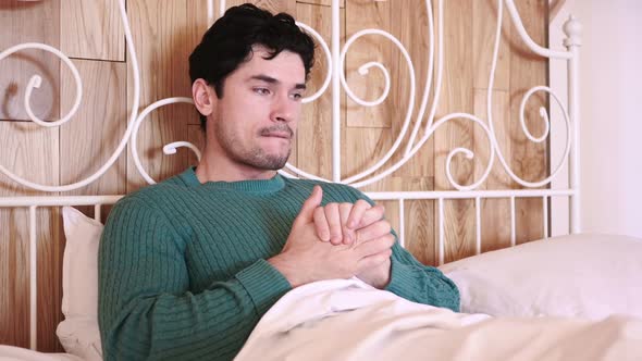 Uncomfortable Man Sitting in Bed at Night Restlessness