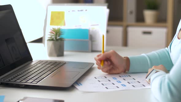 Woman with Laptop Working on User Interface Design 2