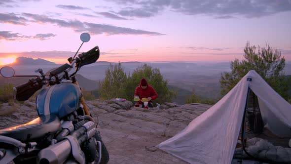 Man Makes Coffee When Camping at Sunset