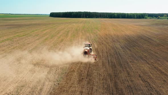 Elevated View Tractor With Seed Drill Machine Sowing The Seeds For Crops In Spring Season