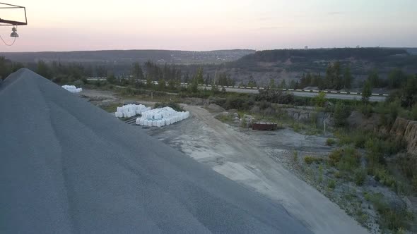 White Bags Clusters Against Grey Road in Summer Evening