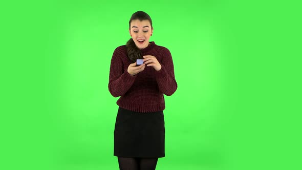 Girl Opens a Small Box with a Surprise and Is Very Disappointed with What She Saw. Green Screen
