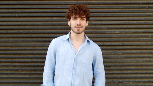 Portrait of a Young Italian Man in Summer Clothes Looking at Camera Seriously