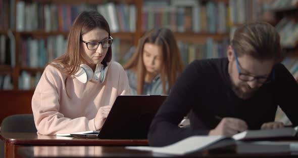 Female Student with Laptop in Library