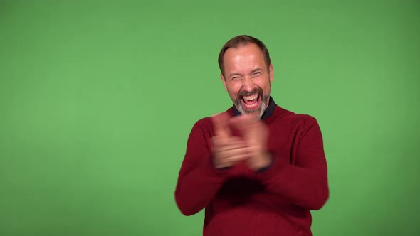 A Middleaged Handsome Caucasian Man Celebrates  Green Screen Background