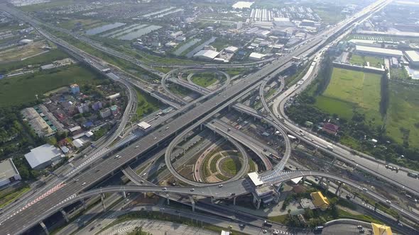 Aerial View of Highway Road Interchange with Busy Urban Traffic Speeding on Road