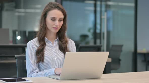 Young Businesswoman Working on Laptop in Office