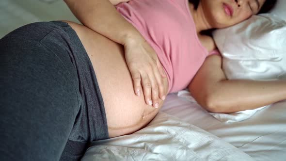 Happy Pregnant Woman and Expecting Baby at Home