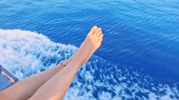 Woman Legs with Blue Sea Water on Background