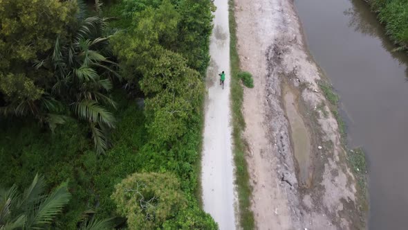 A man cycling in rural path