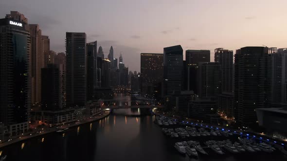 Flying Over Dubai Creek View of the Docks with Yachts and Skyscrapers