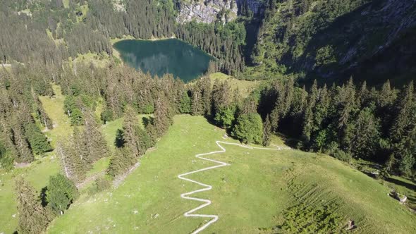 Wonderful zig zag path leads to a mystical mountain lake in the Swiss alps (Hinterburgseeli)