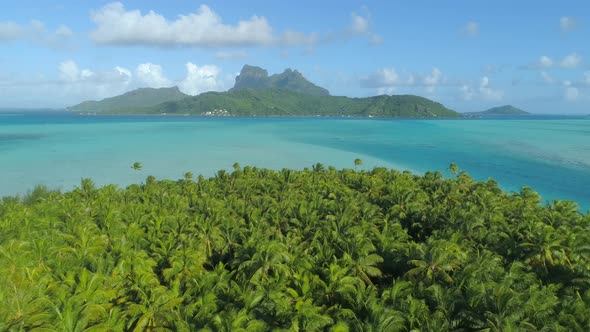 Aerial drone view of a deserted island near Bora Bora tropical island