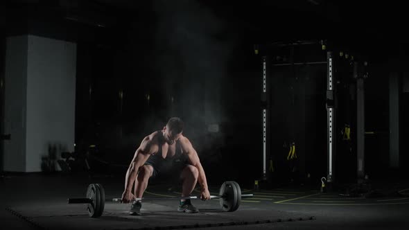 Weightlifting Caucasian Athletic Man Performs Exercises with Barbell Lifts Barbell and Does Weights