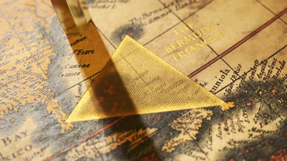 Bermuda triangle marked with golden ink on a vintage map. Compass malfunction.