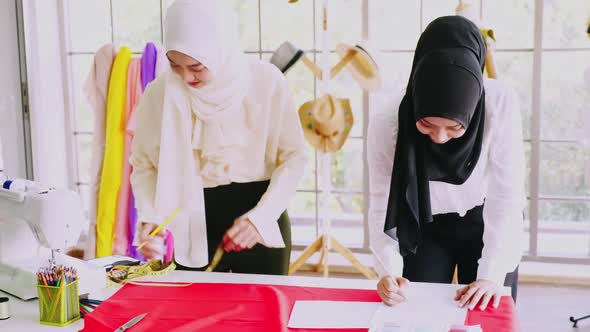 Muslim women fashion designers are in process of creating new clothes collection.