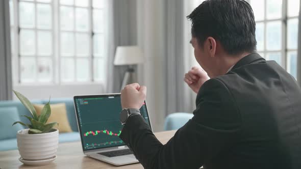 Businessman Being Happy After Seeing Uptrend In The Trading On Computer Screen While Work at Home