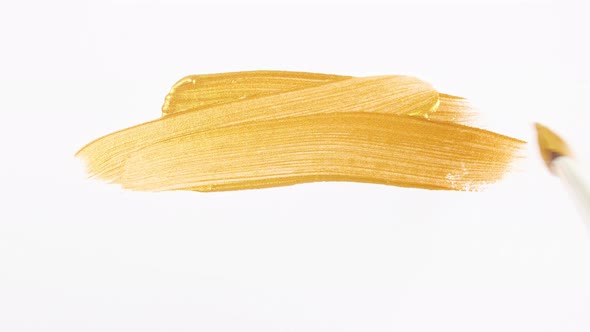 Abstract Brushstrokes of Gold Paint Brush Applied Isolated on a White Background