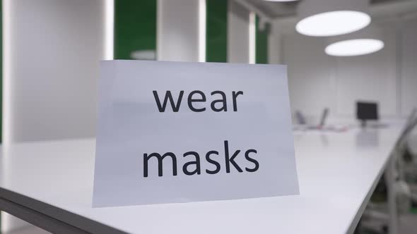 Closeup Wear Masks Message on Table in Empty Office with No People