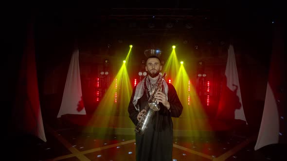 Live Performance of Saxophonist Man with Saxophone Dancing on Concert Musician Stage with Lights