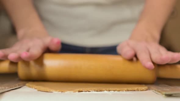 Woman Kneading Dough with Rolling Pin for Ginger Cookies