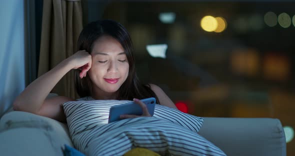 Woman use of mobile phone at night