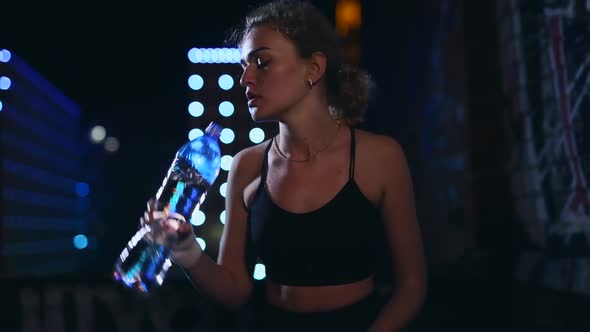 Female Boxer Drinking Water After Street Fight