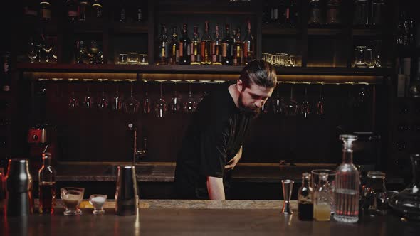 Barkeeper Takes Out Glass and Fills Ice to Prepare Cocktail