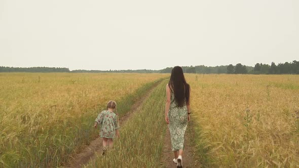 People Walking Through the Field