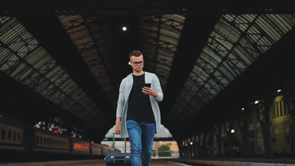 A Man is Walking Along with the Station Platform