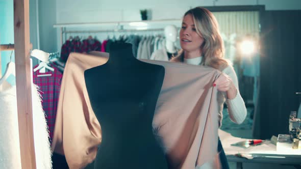 Female Designer is Putting Fabric Onto the Dummy