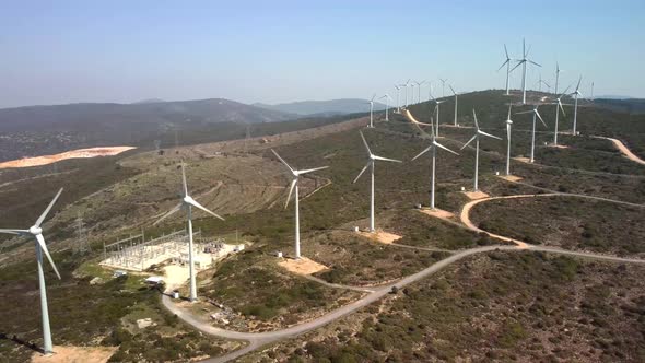 Aerial View Over the Farm Landscape and Wind Turbines Generating Clean Renewable Energy