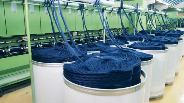 Textile Rolling Machine is Unwinding Hasps of Yarn
