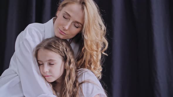 Mother and Daughter Cuddle Carefree