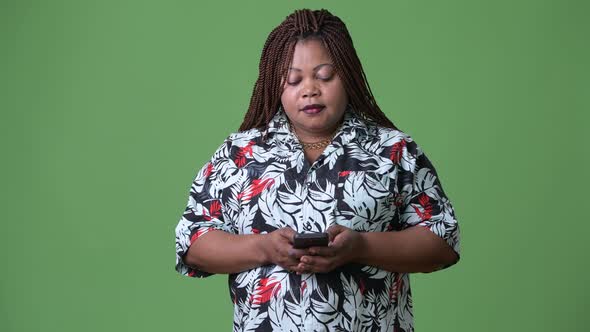 Overweight Beautiful African Woman Against Green Background