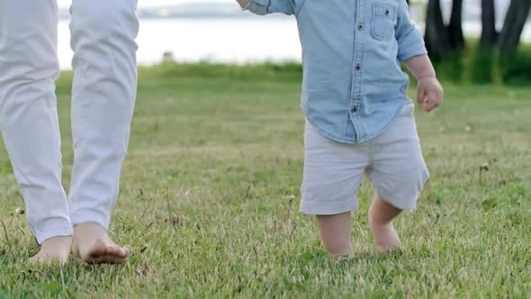 Curious Toddler Walking Barefoot on Grass